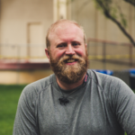 Smiling middle aged man with a beard.