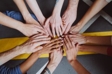 Top view of hands touching each other as a team does.